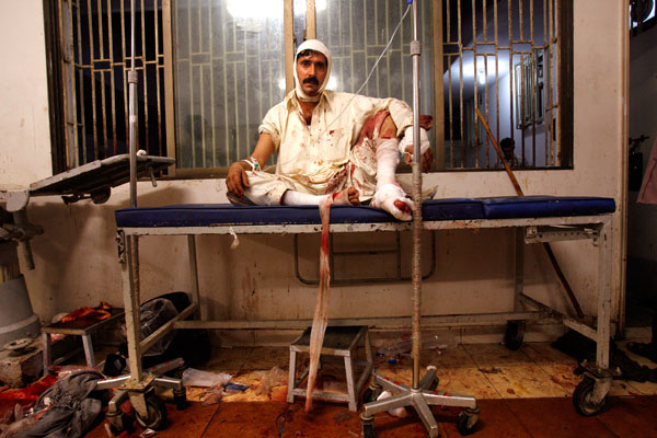 A wounded man sits in shock above the blood-soaked floor at Jinnah medical centre. At least 140 people were killed in a suicide bombing aimed at assassinating former prime minister and opposition leader Benazir Bhutto. October 19, 2007, Karachi, Pakistan © Warrick Page/Getty Images