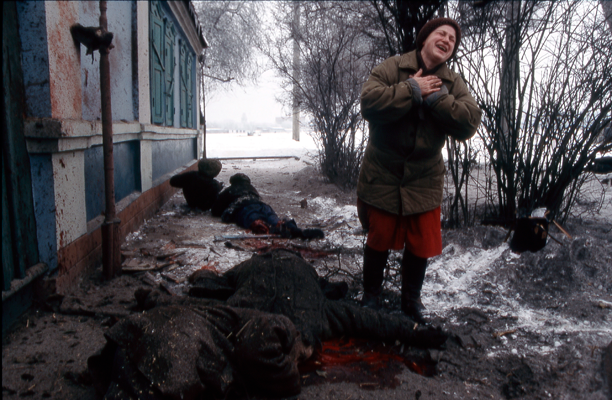 a group of civilians lay dead and dying on the streets of grozny after being hit by an artillery shell fired by advancing russian forces, chechenya 1994 © jon jones